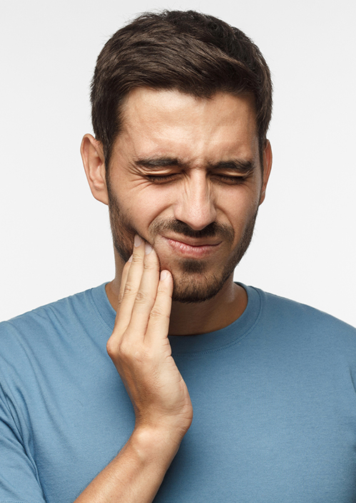 Tooth Ache Concept. Indoor Shot Of Young Male Feeling Pain, Holding His Cheek With Hand, Suffering From Bad Toothache, Looking At Camera With Painful Expression 1041195278 2125x1416