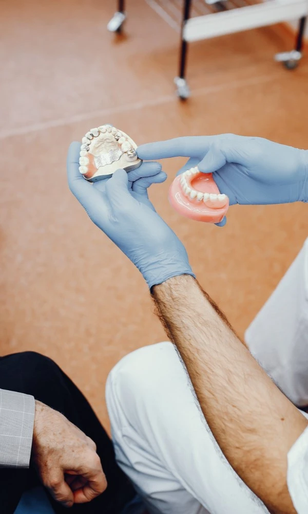 Dentist Holding Dentures