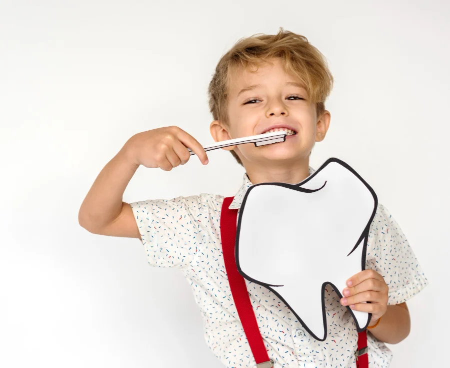 Toddler With Suspenders Showing Oral Health Tips